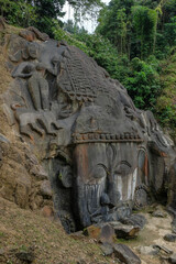 Fototapeta na wymiar Sculptures carved into the rock at the archaeological site of Unakoti in the state of Tripura. India.