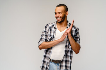 Closeup portrait of happy young handsome african-american man rubbing hands together in anticipation