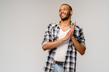 Closeup portrait of happy young handsome african-american man rubbing hands together in anticipation