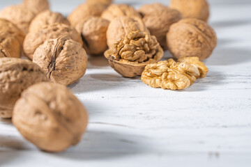 Walnuts kernels on white wooden desk, stock photo