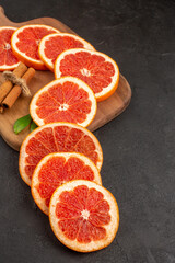 front view fresh grapefruit slices on dark background color fresh healthy life diet juice fruit
