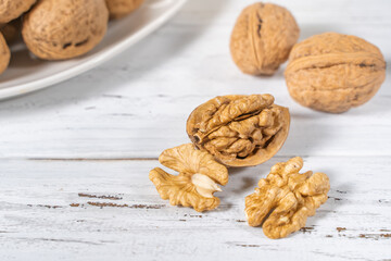 Walnuts kernels on white wooden desk, stock photo