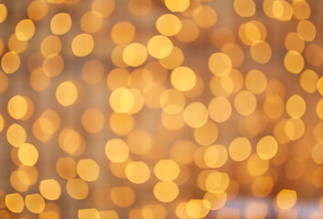 Obraz premium Golden beautiful blurred bokeh background with copy space.