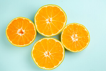top view fresh tangerine slices on light-blue background photo color fruit orange citrus