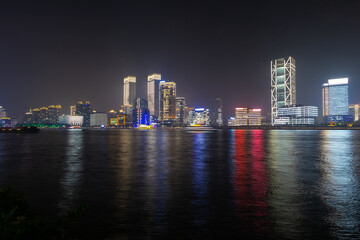 Fototapeta na wymiar city in china is reflected in the river at night