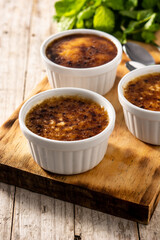 Homemade creme brulee in bowl on wooden table