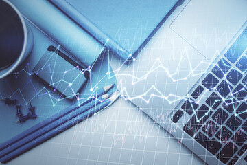 Double exposure of forex graph drawing over desktop background with computer. Concept of financial analysis. Top view.