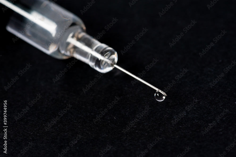 Wall mural syringe isolated on black background