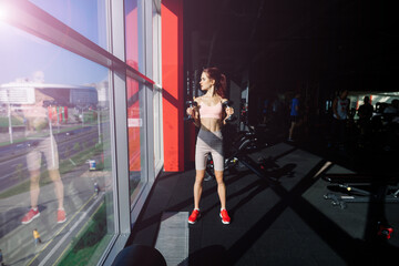 Fototapeta na wymiar Athletic girl in sportswear performs exercises with barbell, dumbbells. Fitness, healthy lifestyle