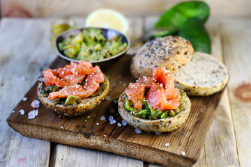 Salmon avocado sandwiches on buns with seeds. The keto diet. Healthy breakfast or snack.