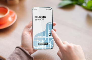 Woman using smartphone with opened delivery service tracking app, checking order status