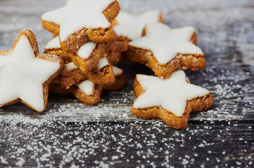cinnamon stars with powdered sugar on wooden background
