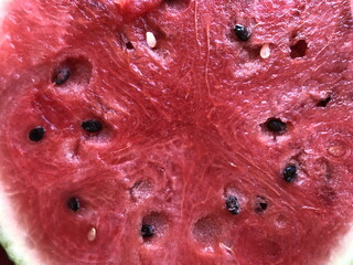 juicy red watermelon with black bones close up