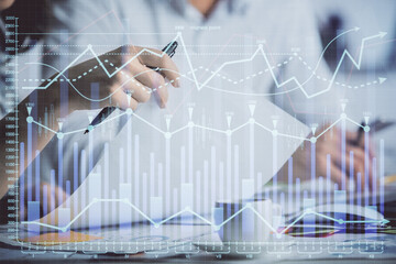 Double exposure of forex graph drawing over people taking notes background. Concept of financial analysis
