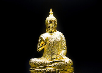 Gold buddha statue  on back background.