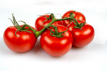 a bunch of large tomatoes on a white background