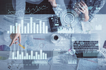 Double exposure of man and woman working together and financial graph hologram drawing. market analysis concept. Computer background. Top View.