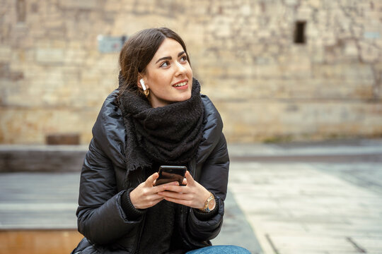 Girl Watching A Phone On Street