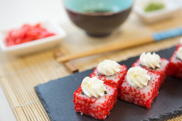 Maki roll with salmon, popular Japanese cuisine. Sushi roll with fish, cream cheese and vegetables