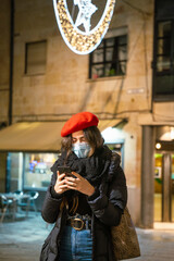 girl with phone and mask on street