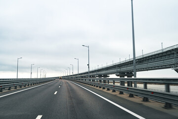 Fototapeta na wymiar Empty highway with asphalt road and cloudy sky
