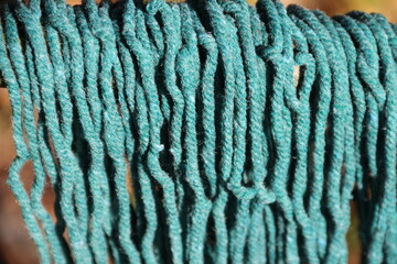 Hanging chemical green dyed cotton rope on the wooden clothesline 