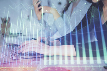 Multi exposure of woman hands typing on computer and financial graph hologram drawing. Stock market analysis concept.