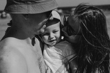 Fototapeta premium Happy family spends time by the sea. Happy together. Black and white photo