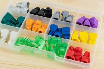 box full of caps and connector for wire rj 45 multicolored closeup