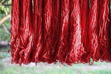 Red  cotton rope dyed under sun light on washing line