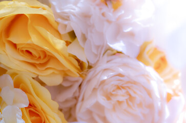 Background of yellow blooming roses is decorated on the wedding centerpiece.