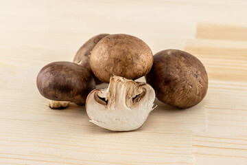 royal brown champignons large stacked on a wooden cutting board