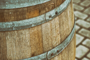 old and weathered oak barrel with iron hoop close-up on a square background