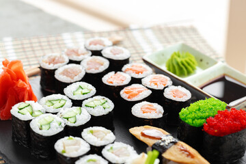 Maki sushi set served on black stone tray