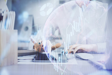 Double exposure of forex chart sketch hologram and woman holding and using a mobile device. Financial market concept.