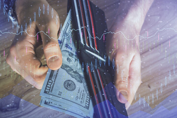 Multi exposure of forex graph drawing hologram and USA dollars bills and man hands. Technical Analysis concept.