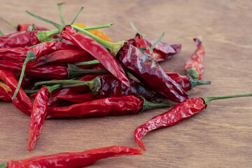 group of hot red dried chili peppers on wooden background