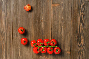 Cherry tomatoes on a branch on a wooden board