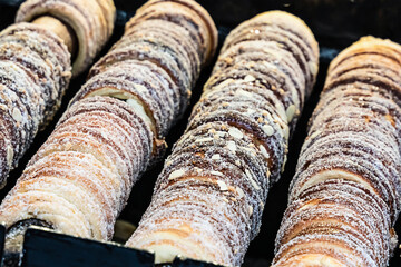 trdelnik traditional dessert at fairs of Hungary and the Czech Republic is cooked on an open fire close-up