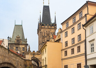 Prague, Czech Republic-February 02, 2019. Tops of the buildings and the Lesser Town (Mala Strana) Bridge Towers of the Charles bridge at old part of Prague city.