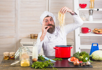Chef. Bearded chef with spaghetti. Noodles. Kitchen. Food. Cooking. Kitchen utensils. Chef in uniform. Kitchenware. Cook.