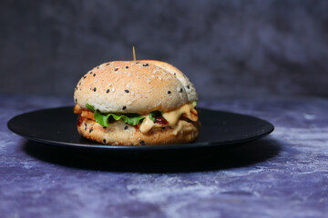  beef burger on a plate on dark background close up 