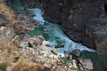 Tourists in central part of one of the deepest ravines of the world, Tiger Leaping Gorge in Yunnan, Southern China