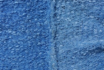 light blue fabric texture from a piece of crumpled matter  with a seam