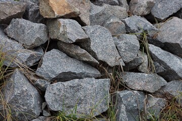 gray texture of large pieces of stones in a pile on the street