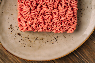 Fresh ground beef pork on a plate with seasonings