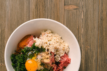 Cooking meat cutlets, in bowls mixed far, egg and seasonings