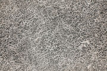 Dry cracked asphalt texture. Black old grunge road closeup macro background.