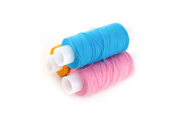 stack of skeins of pink and blue cotton threads for sewing and darning on an isolated background