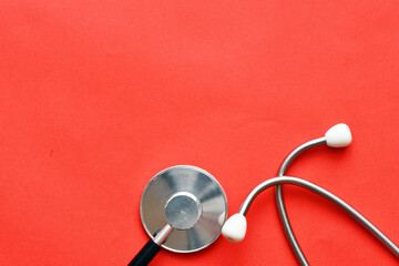 Stethoscope on red background. Heart health, health insurance concept, world heart day, world health day, world hypertension day